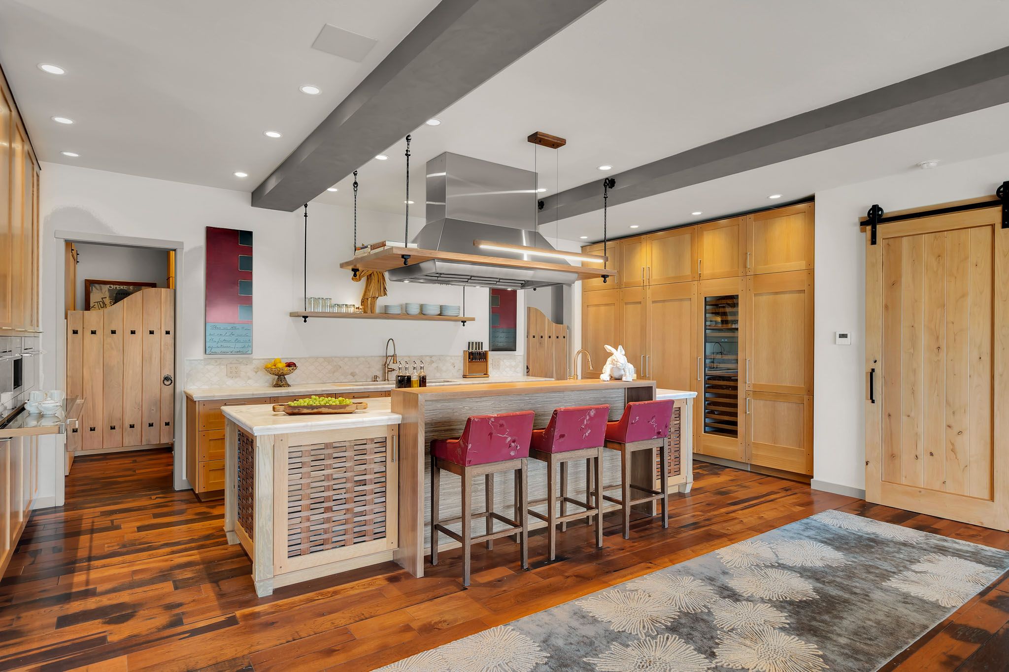 Modern basement renovation featuring wood paneling, recessed lighting, and sleek bar area with contemporary design elements.