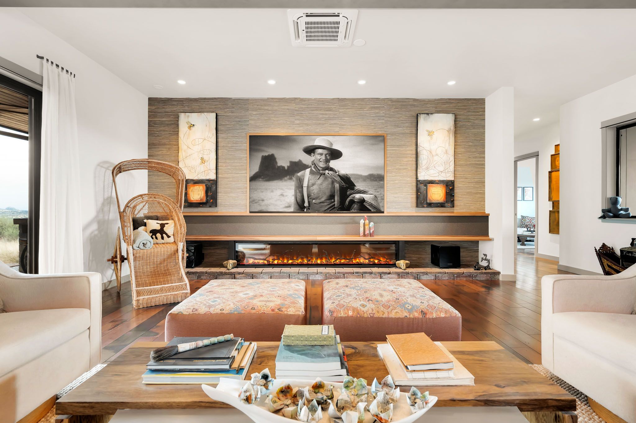 Expansive modern living area featuring white walls, built-in shelving, and natural wood accents.