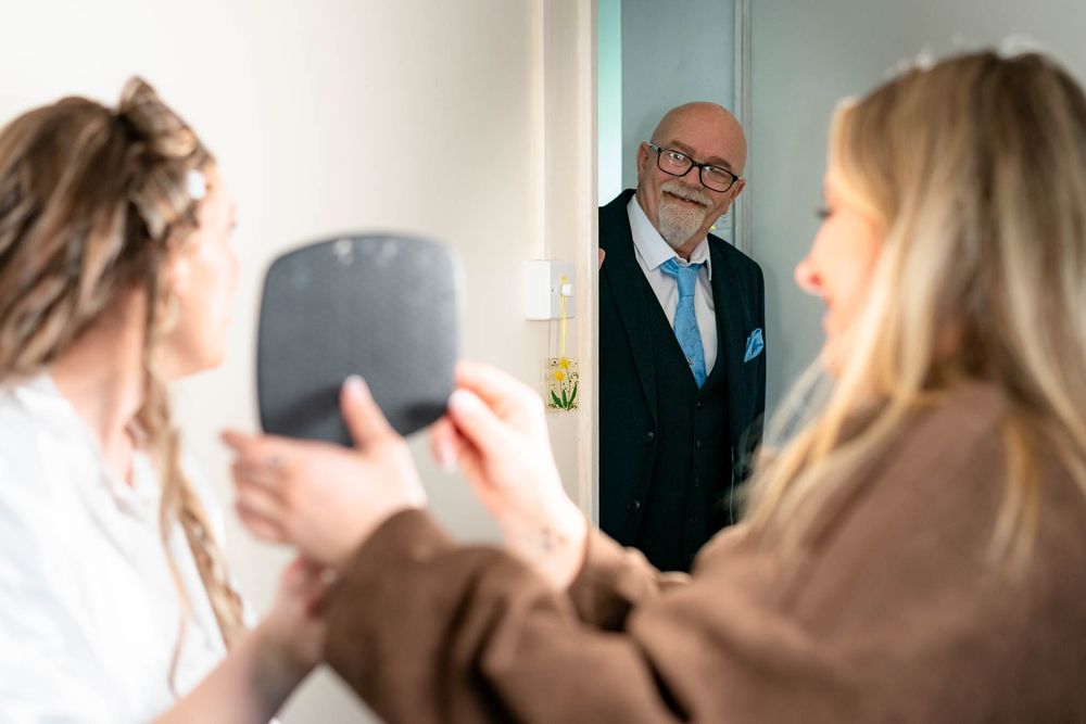 Father of the Bride watching bridal prep at Devon Wedding