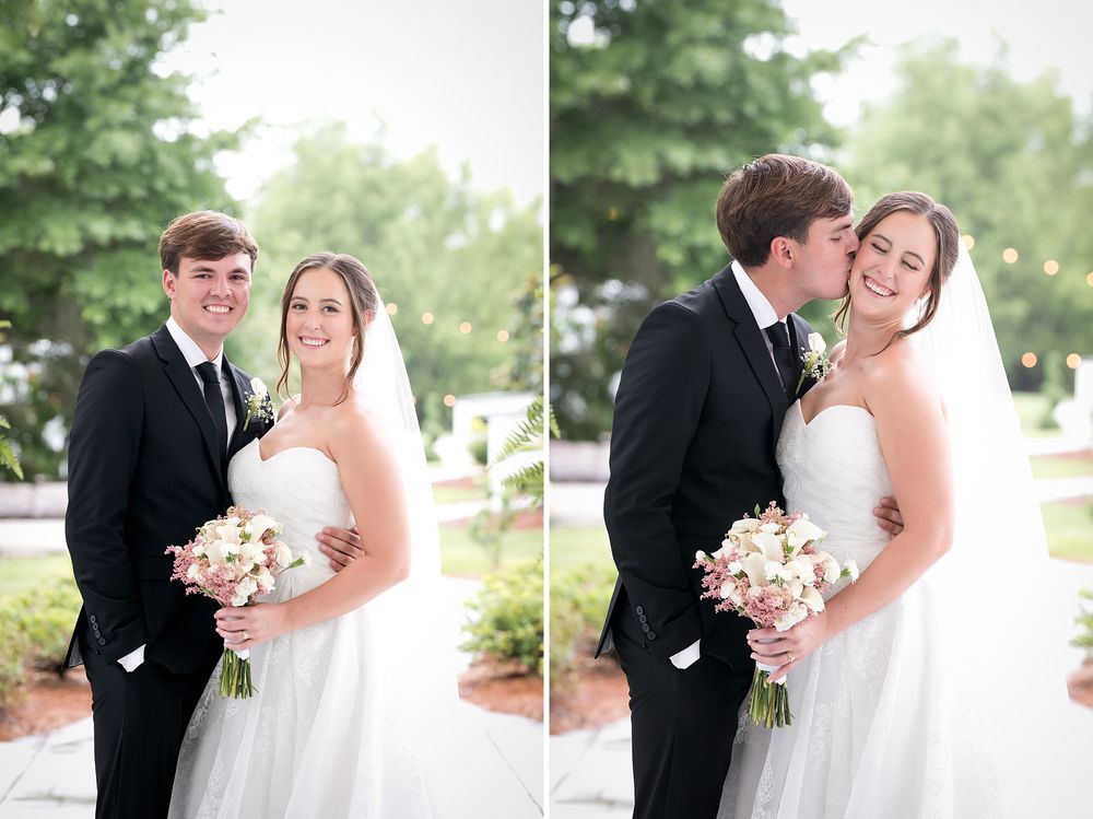 Bride and groom pose together outdoors, smiling, as groom kisses bride on cheek while she holds a bouquet.