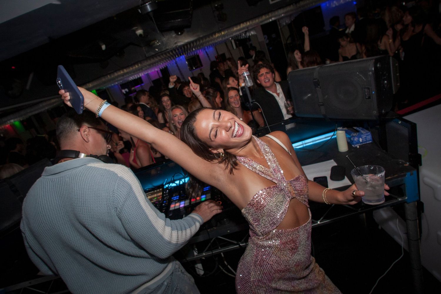 A party girl dances with the DJ at a Los Angeles Nightclub