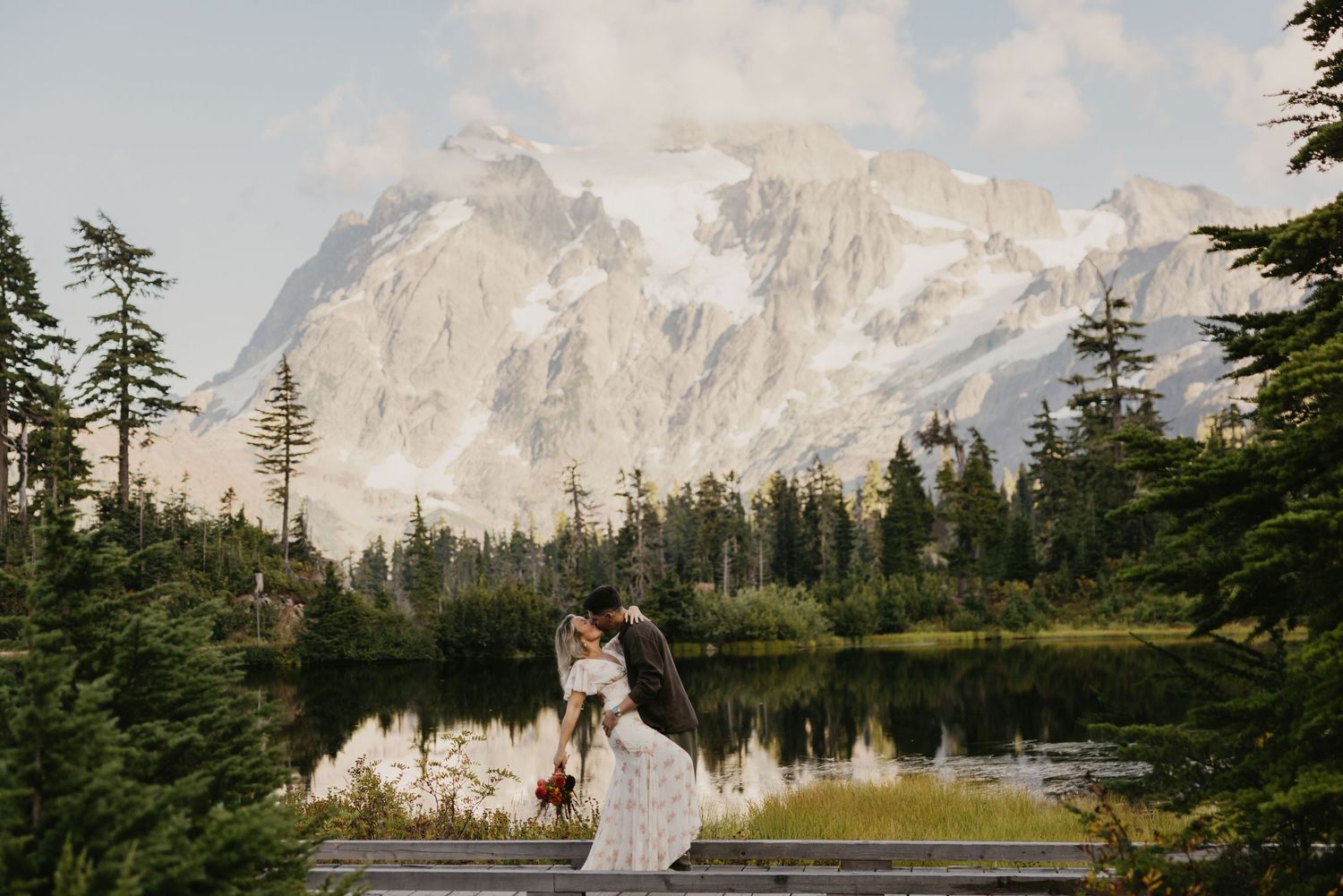 Couple sharing a romantic kiss at Picture Lake with Mount Shuksan backdrop in Washington State.