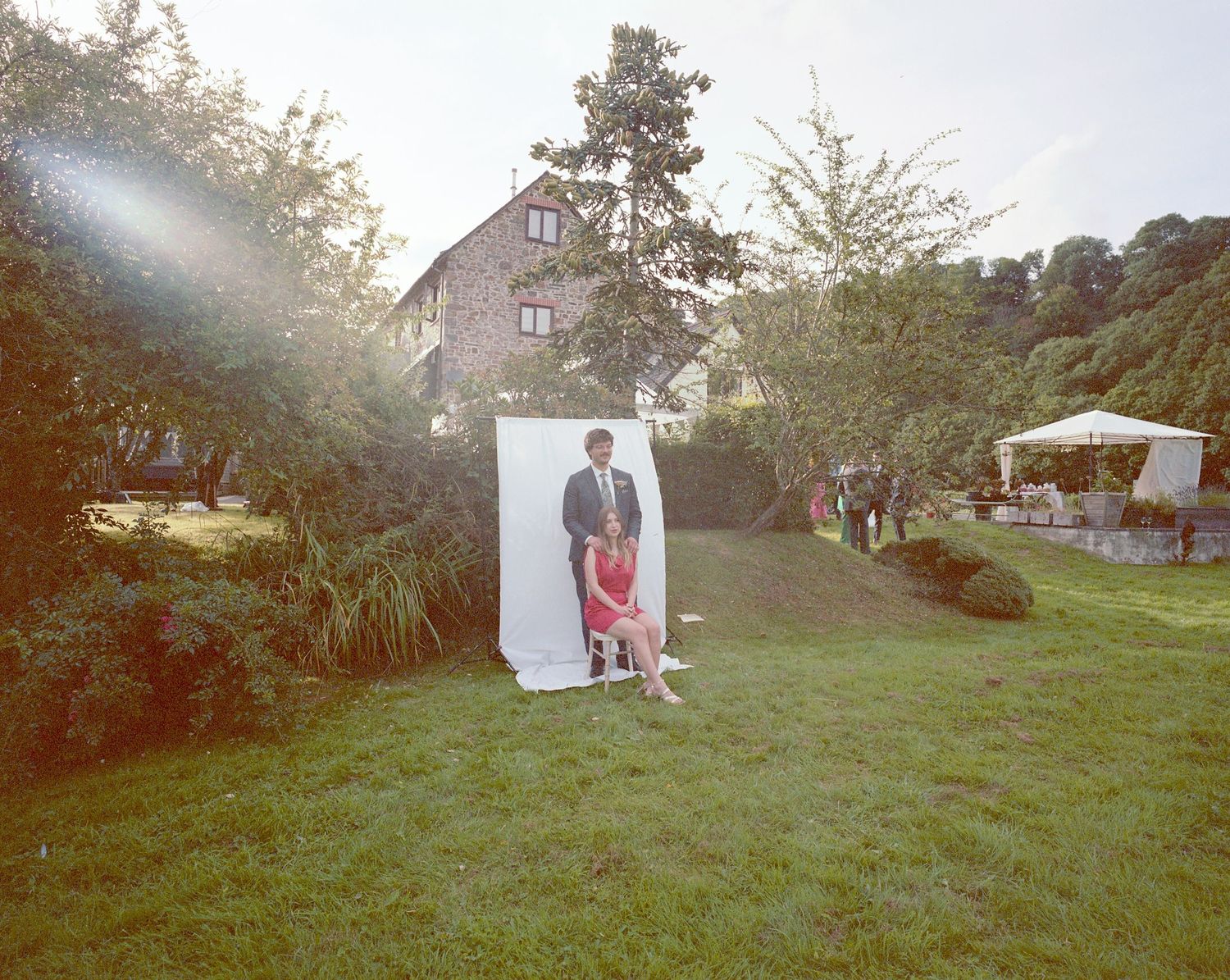 Outdoor photography session setup with professional lighting equipment in a grassy field.