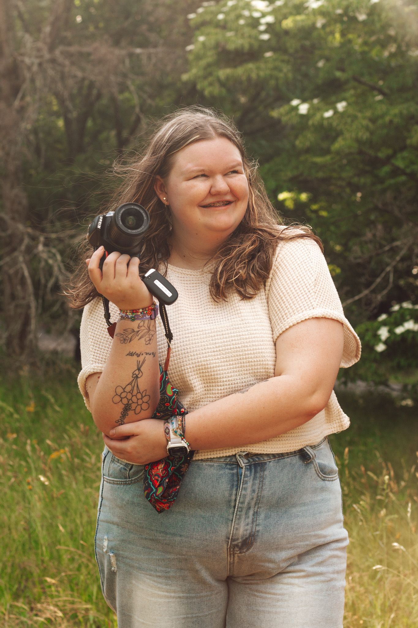 Series of shots showing photographer holding camera in different positions against natural outdoor backdrop.