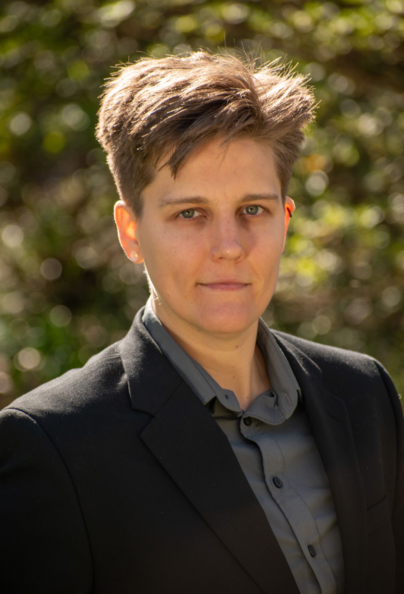 Portrait series showing poses in formal attire against blurred natural background.