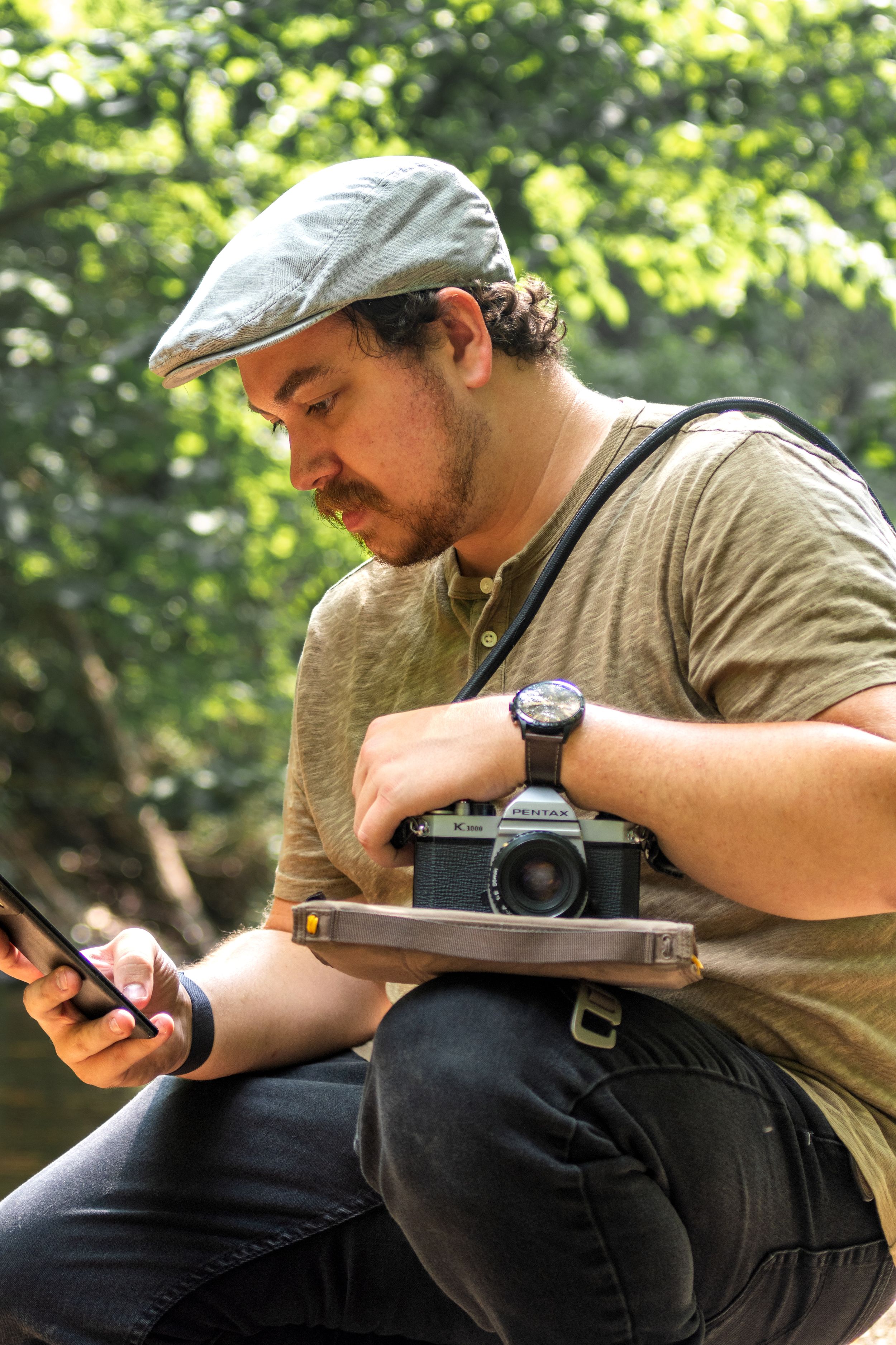 Outdoor photography scene with vintage camera and mobile device.