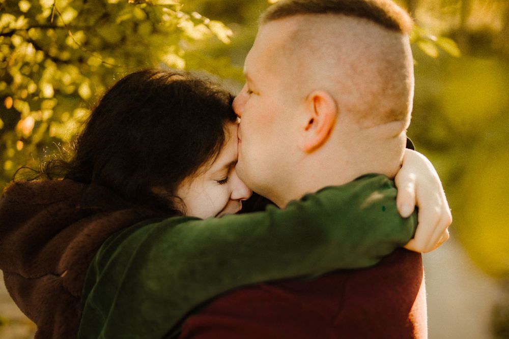 An intimate close-up moment captured in warm golden sunlight.
