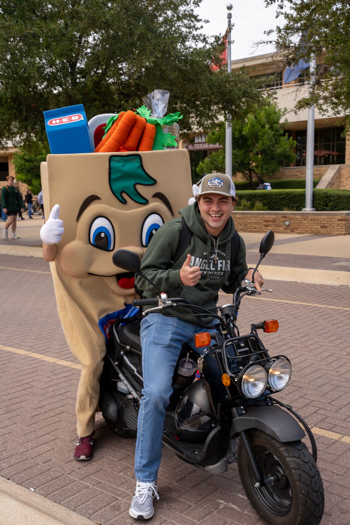 HEB Buddy on a bike with a customer