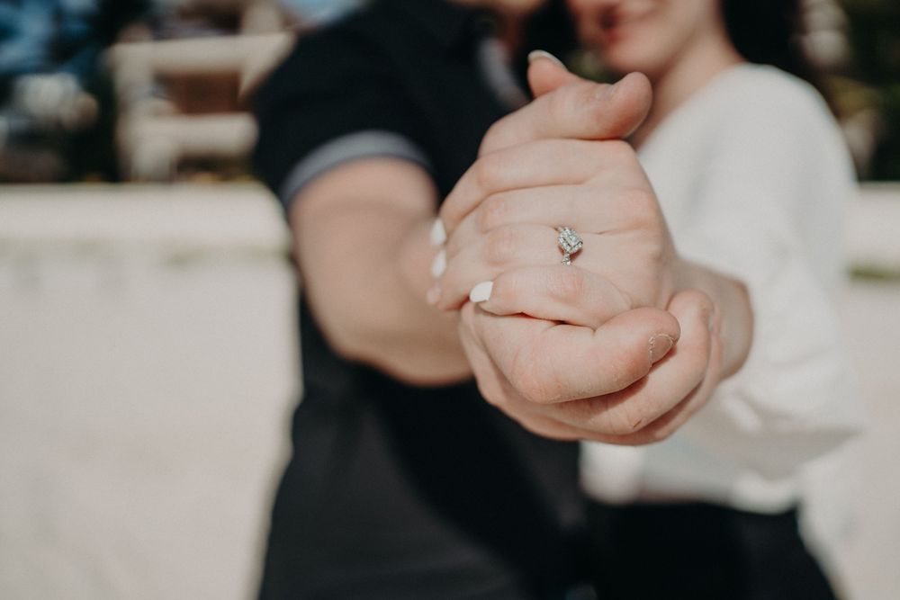 Close-up shot of clasped hands showing an engagement ring in natural lighting photoshoot in Puerto Morelos.