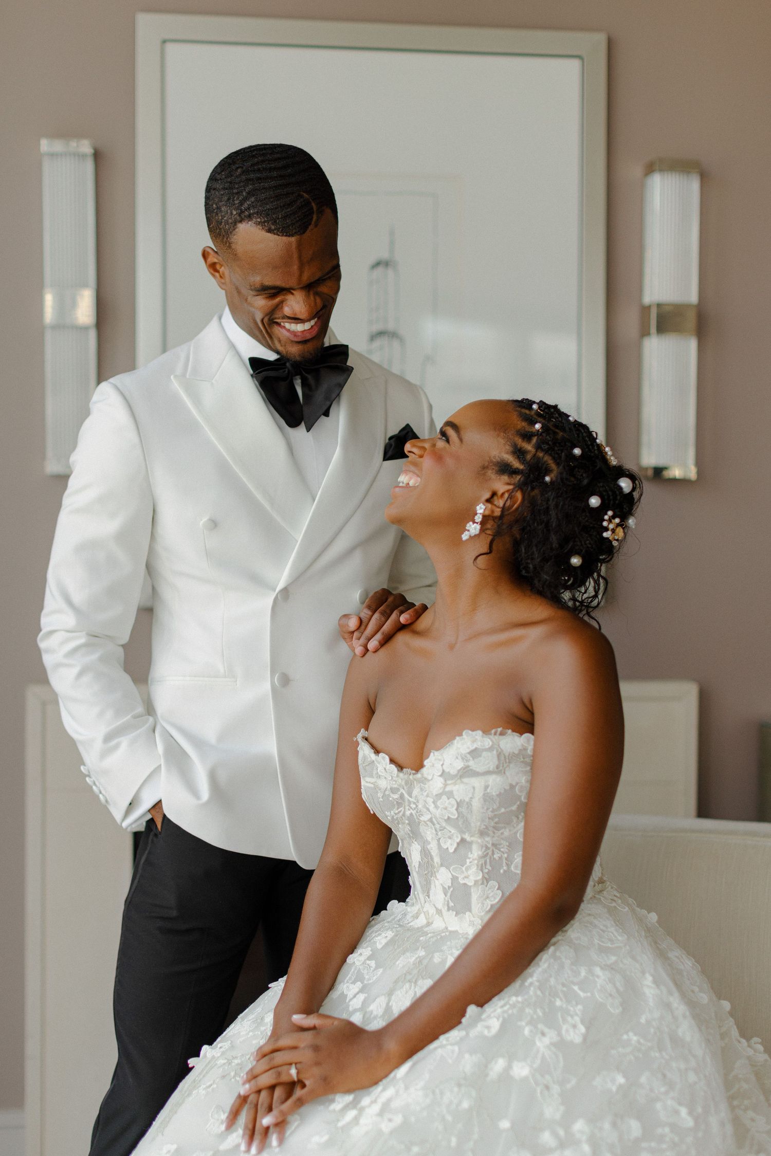 Candid moment of pure joy between newlyweds in formal wedding attire.