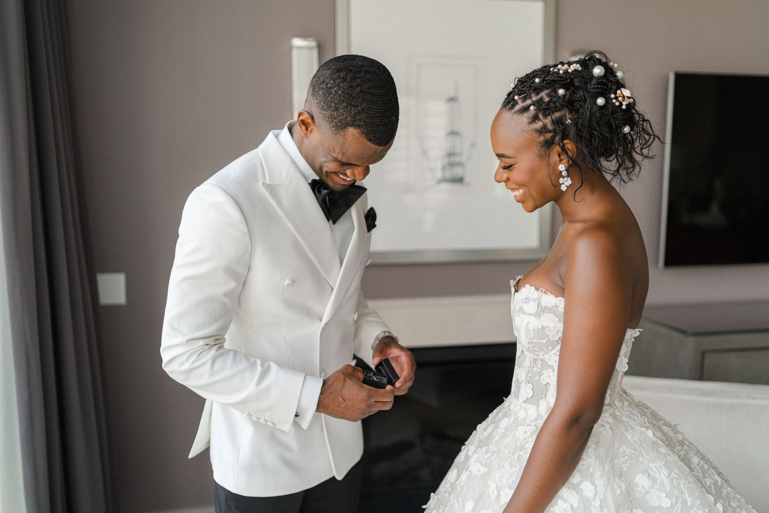 Intimate pre-wedding moment as couple prepares in formal attire.