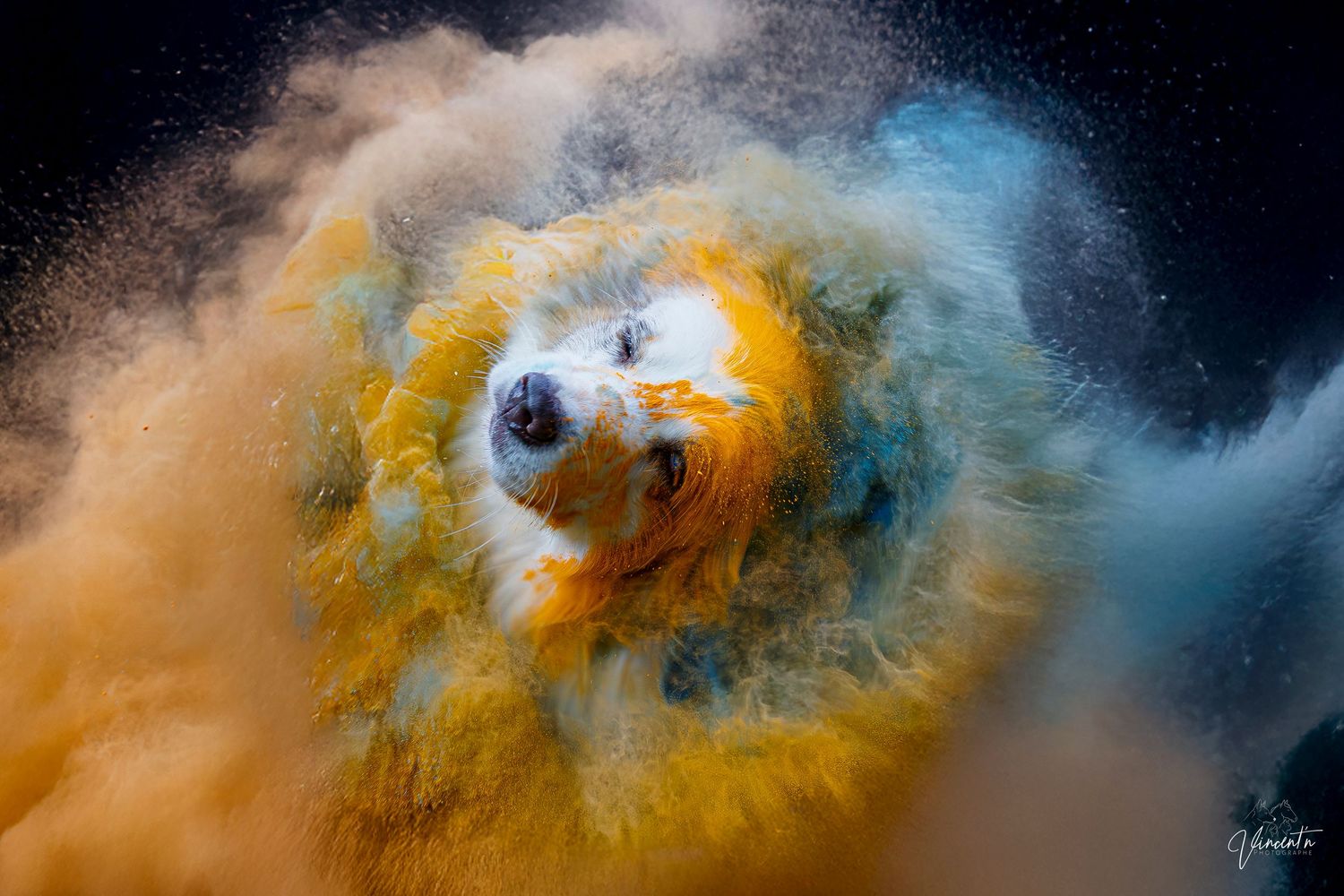 Abstract fluid art with swirling clouds of orange, blue and black paint creating a cosmic nebula-like effect.