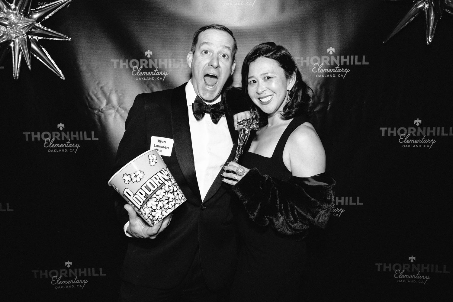Black and white photo booth strip showing four sequential candid poses of a couple at a formal event.