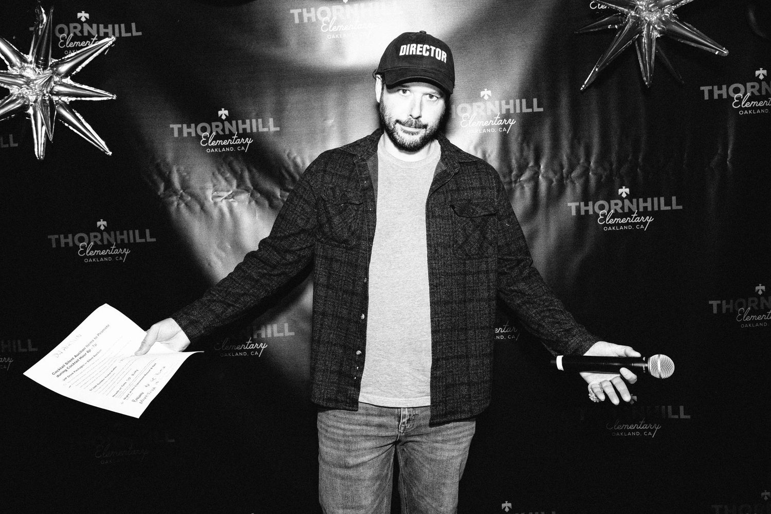Person in casual attire poses against black backdrop with illuminated star decorations and Thornhill branding.