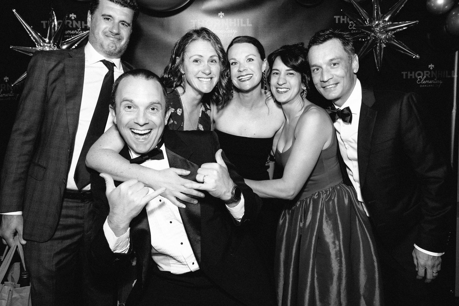 A series of black and white party photos showing people celebrating and posing together at a formal event.