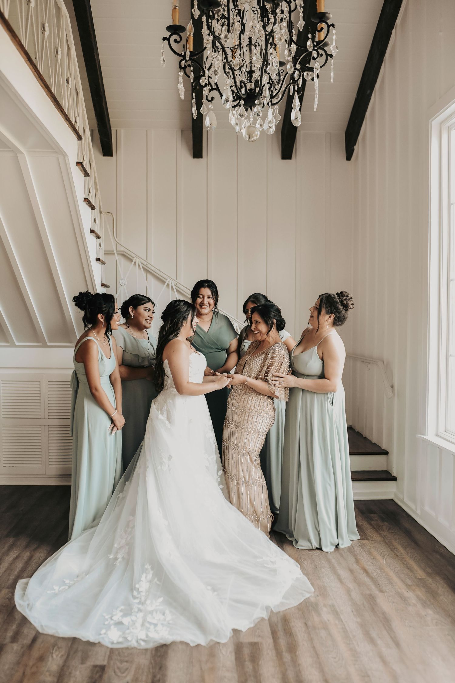 Bride laughing with bridesmaids while preparing for her spring wedding day