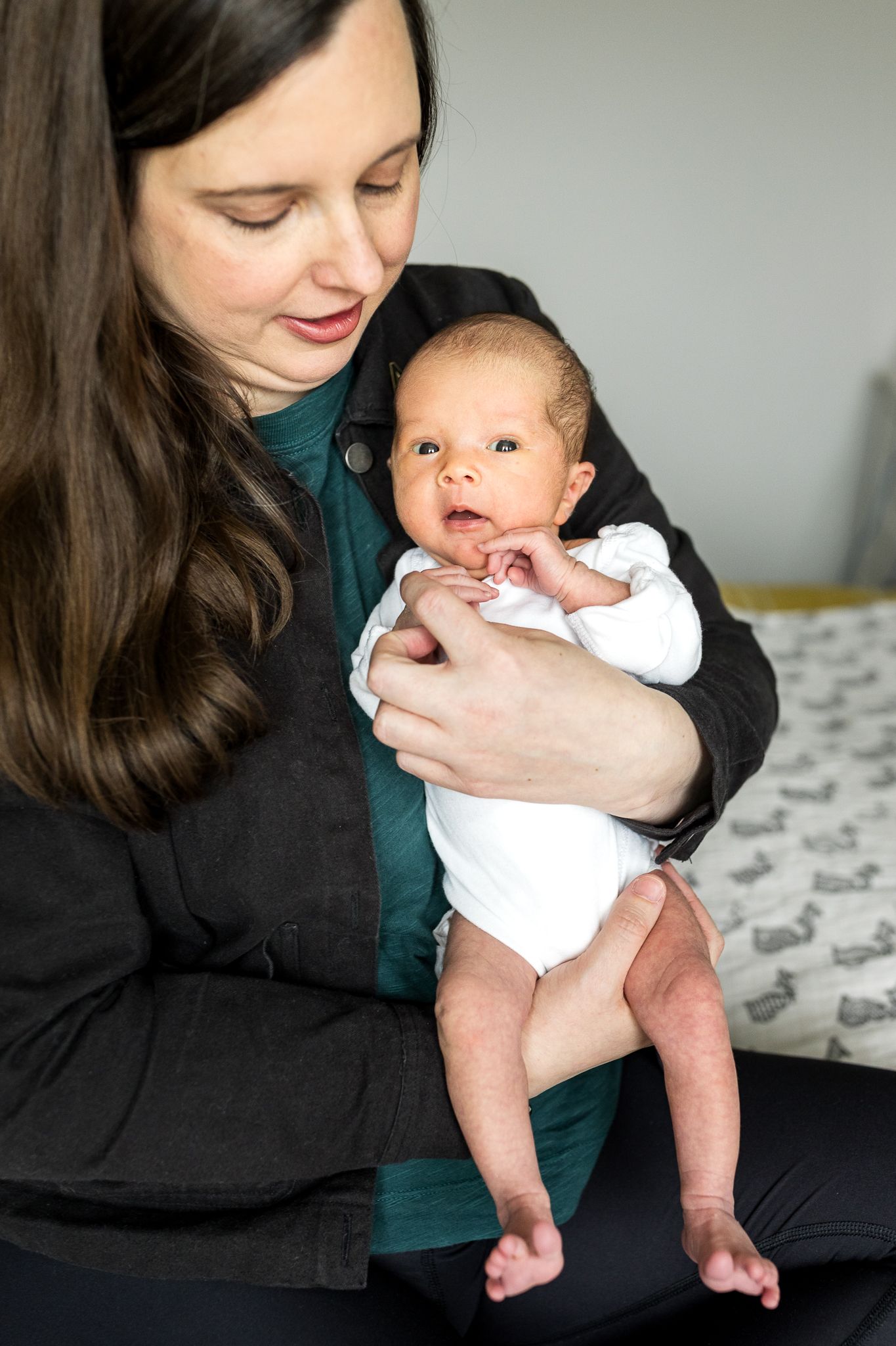 two week old baby girl in mum's arms