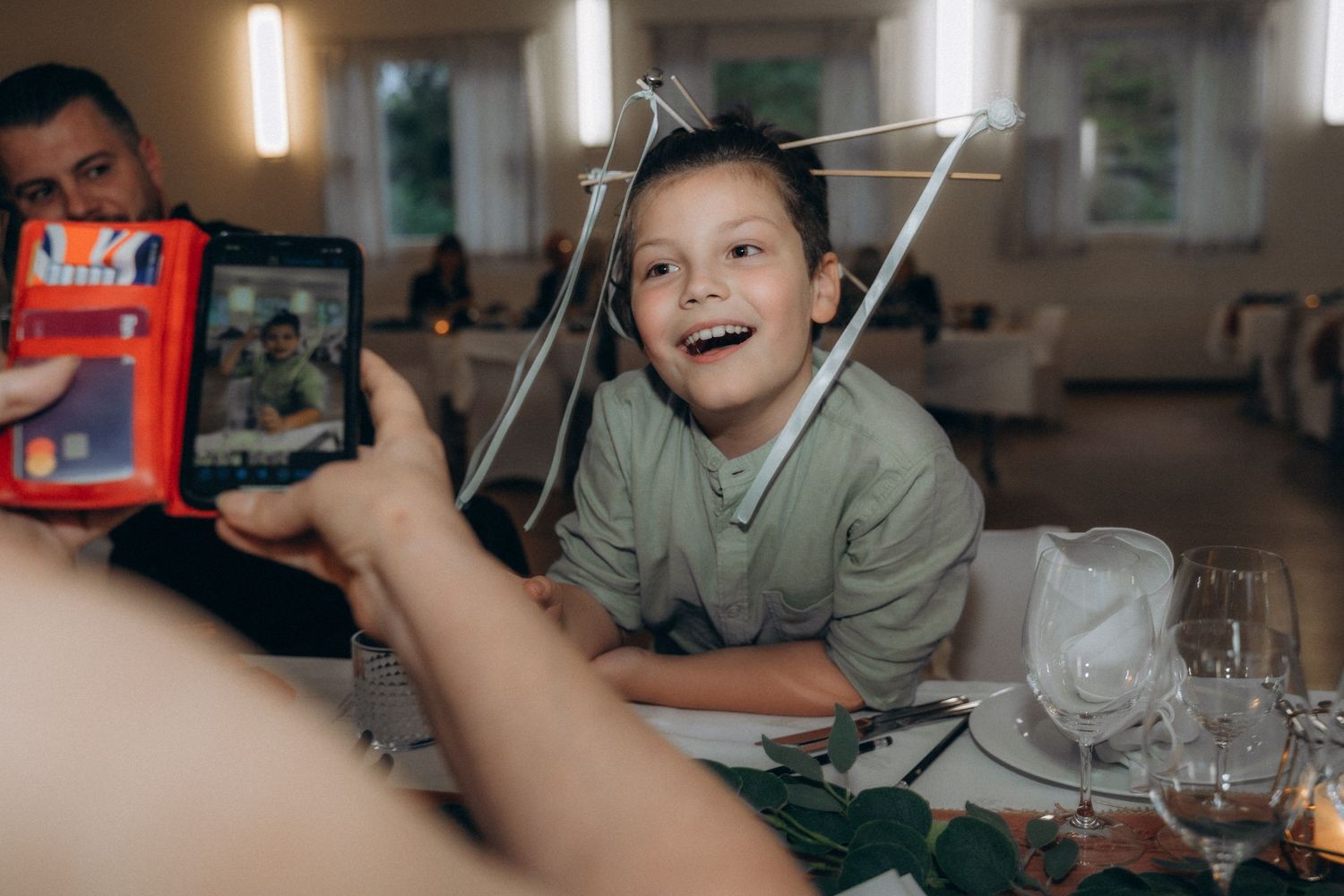 happy child reacting to camera during relaxed wedding reception candid documentary wedding photography Poliisien koti Lauttasaari Helsinki