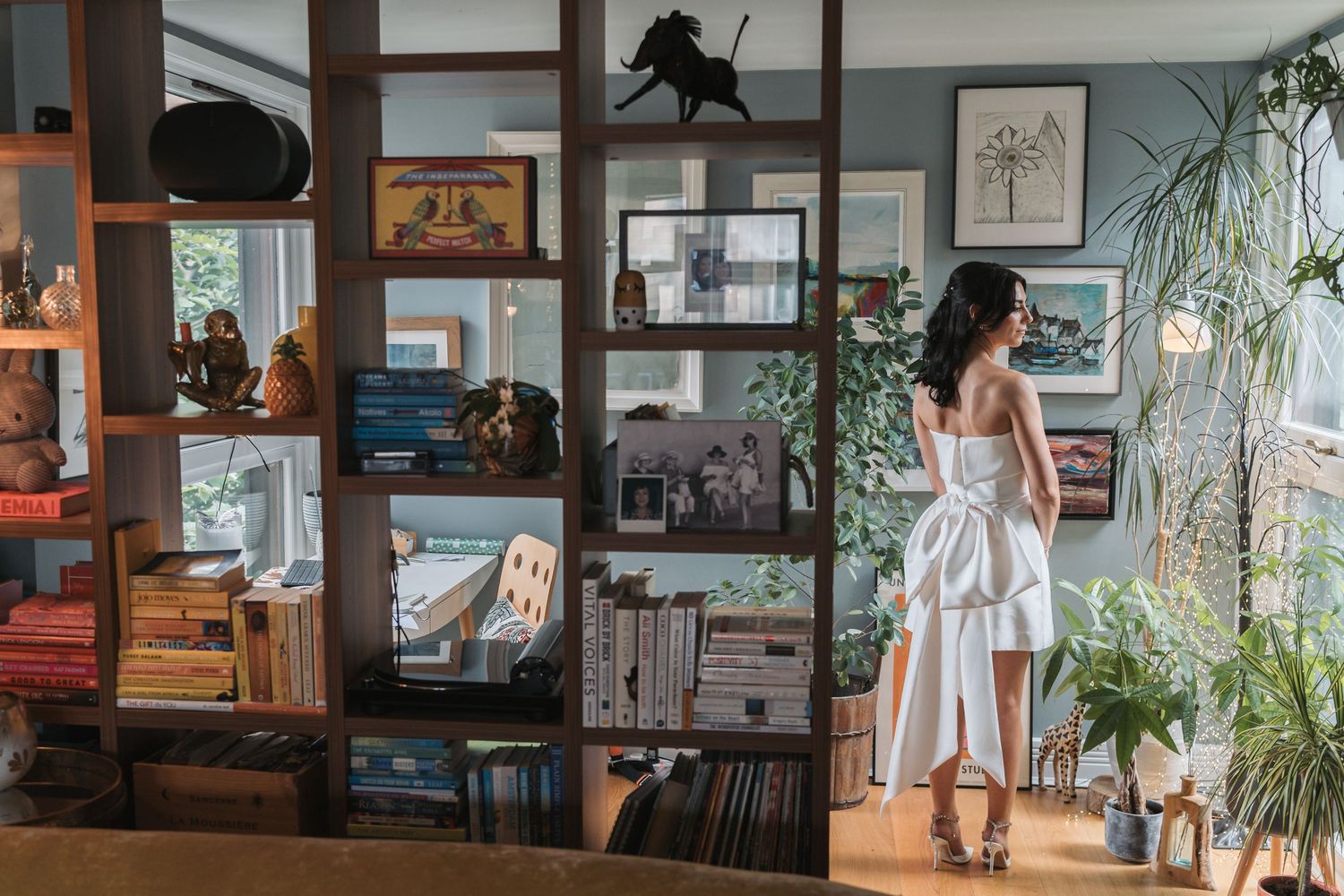 A series of connected interior home office scenes showing a desk setup with plants, computer monitors and natural lighting.