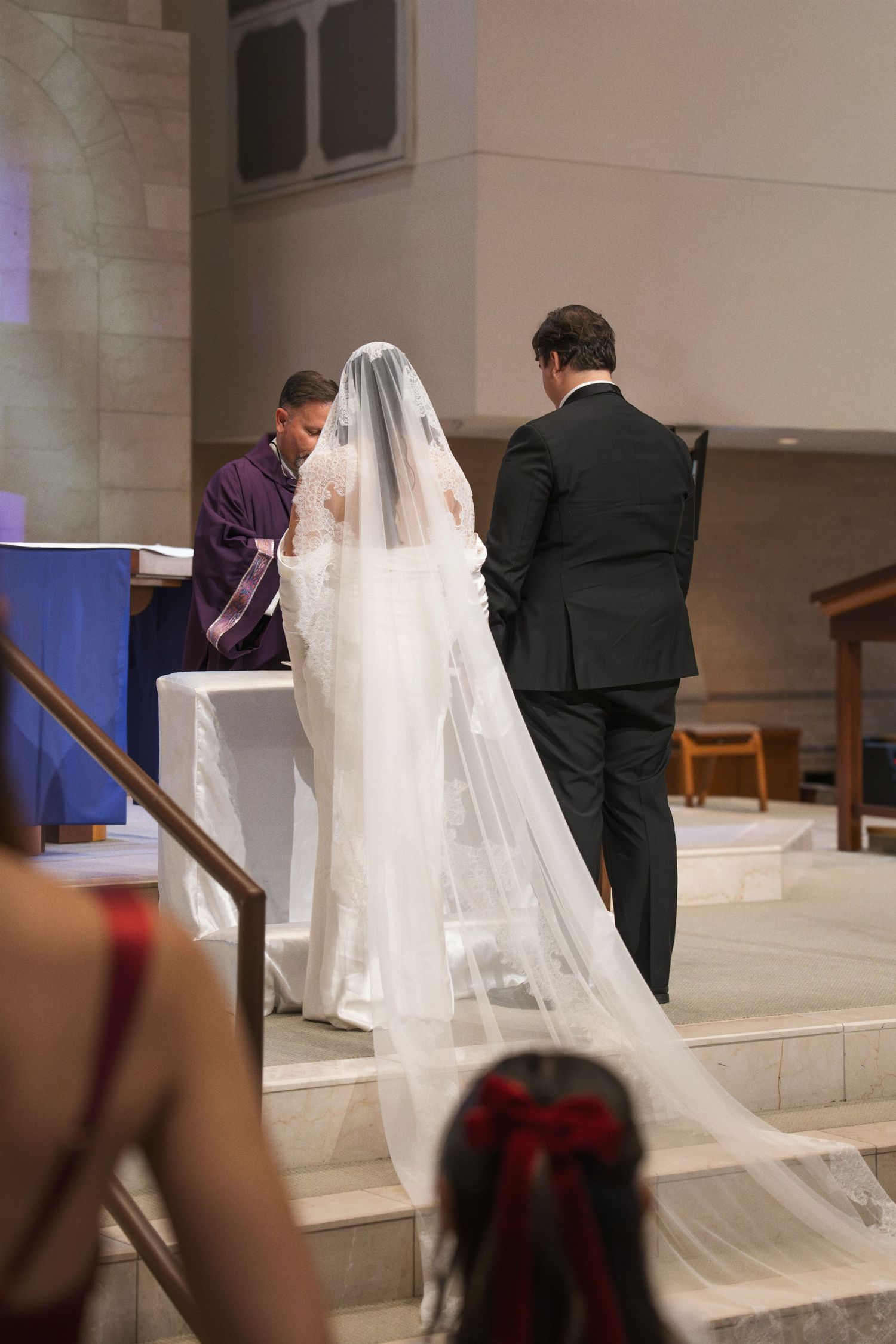 A wedding ceremony sequence showing a couple ascending church steps with the bride wearing a flowing white veil.