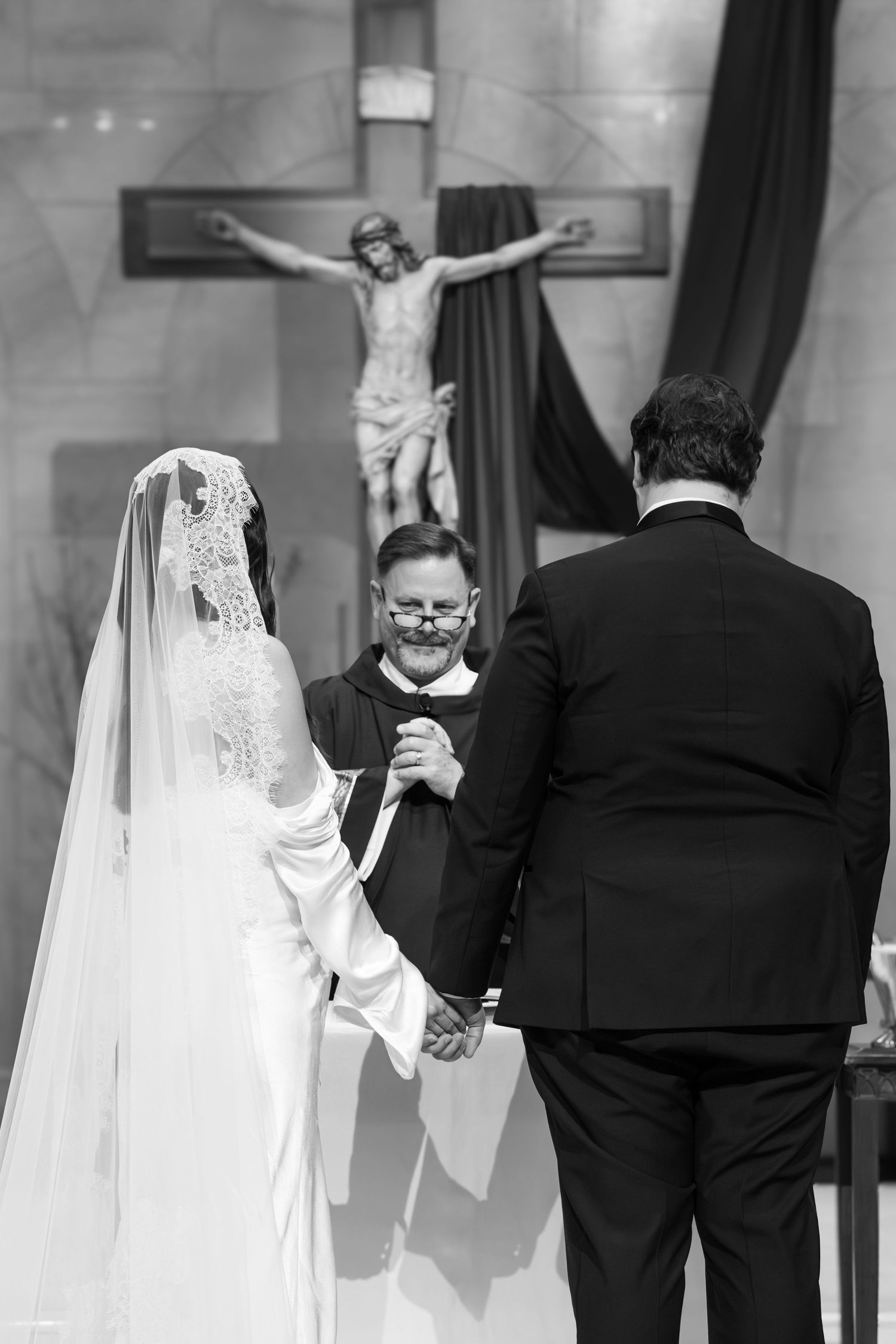 A sequence of black and white wedding ceremony photos showing a couple holding hands during their vows at the altar.