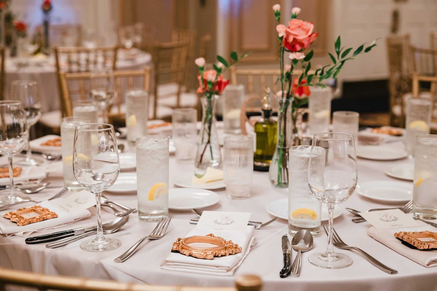 Elegant wedding reception table setting with roses and gold chairs in the Dome Room at the Lenox Hotel in Boston