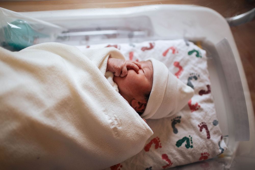 A newborn baby at the hospital during a Fresh 48 session in natural light in Seattle WA