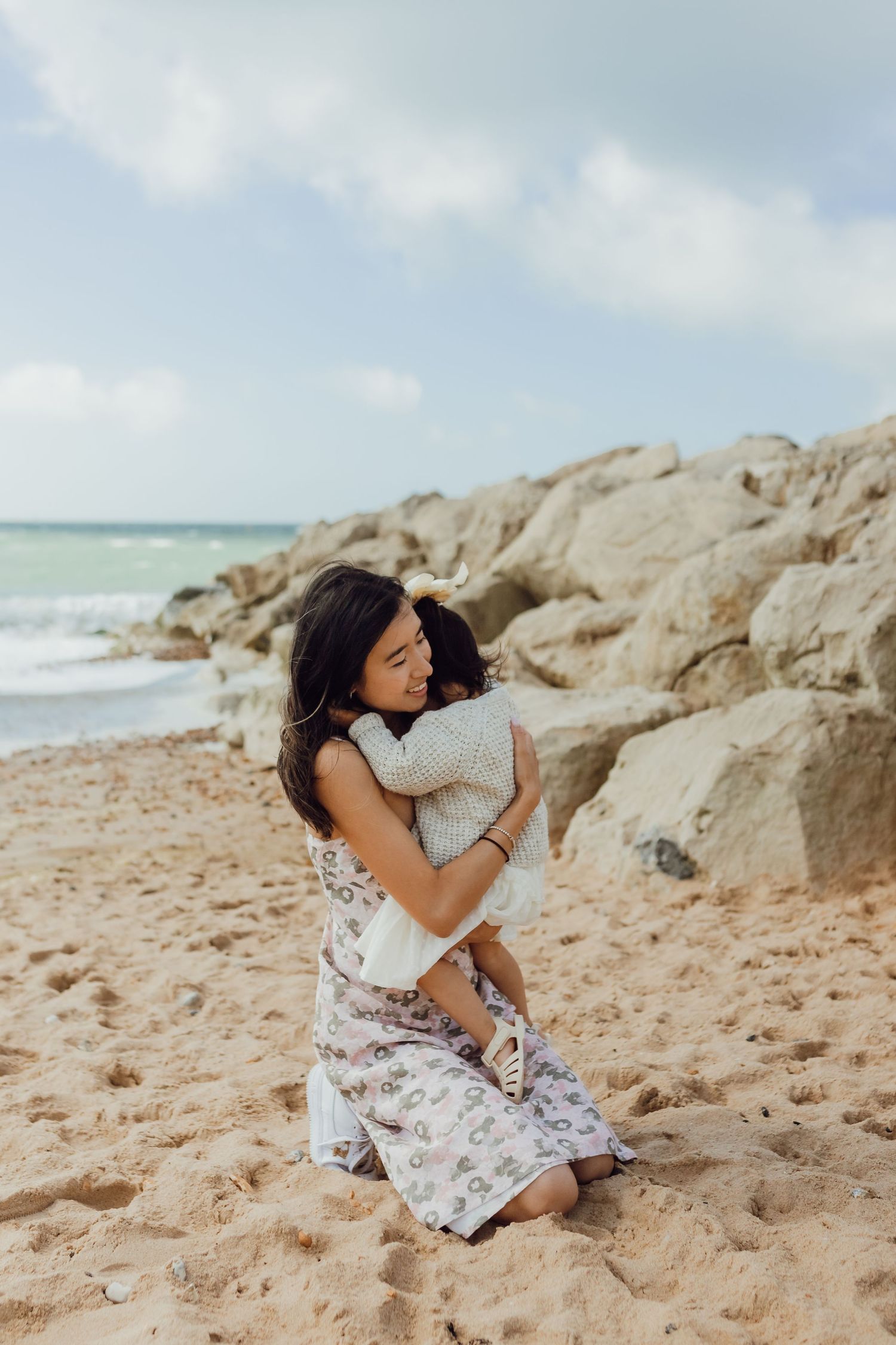 Intimate family moment on the beach in Dorset with soft overcast light.