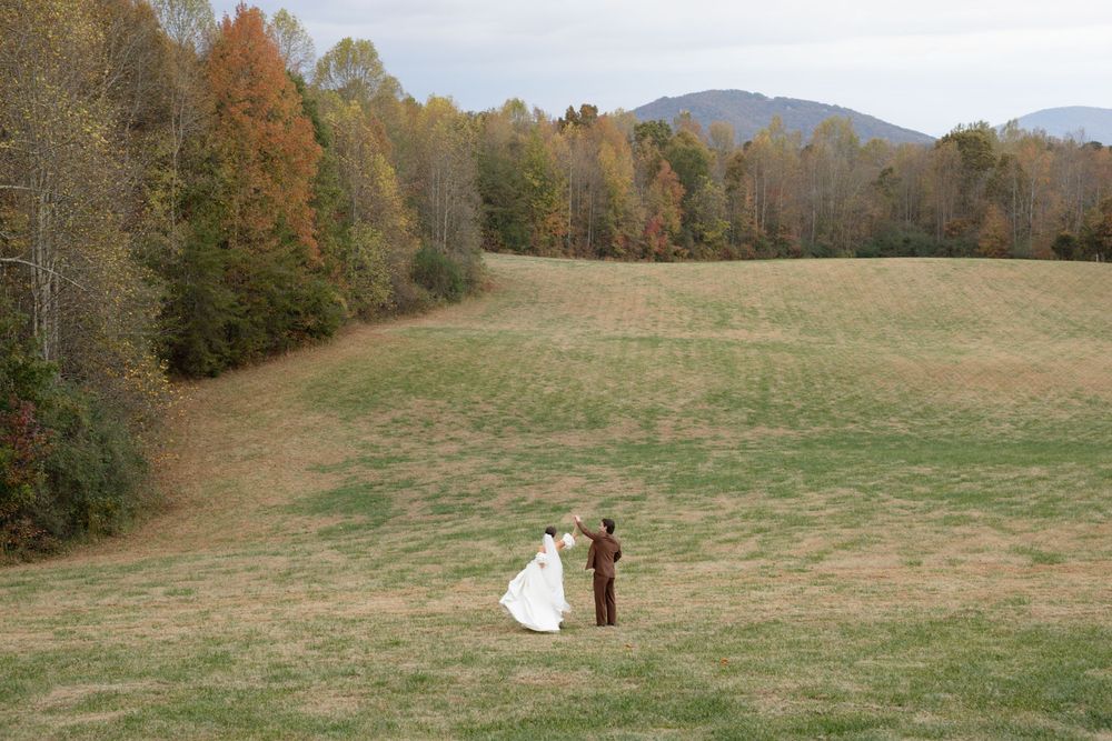 Rolling hills and autumn trees create a scenic landscape backdrop.