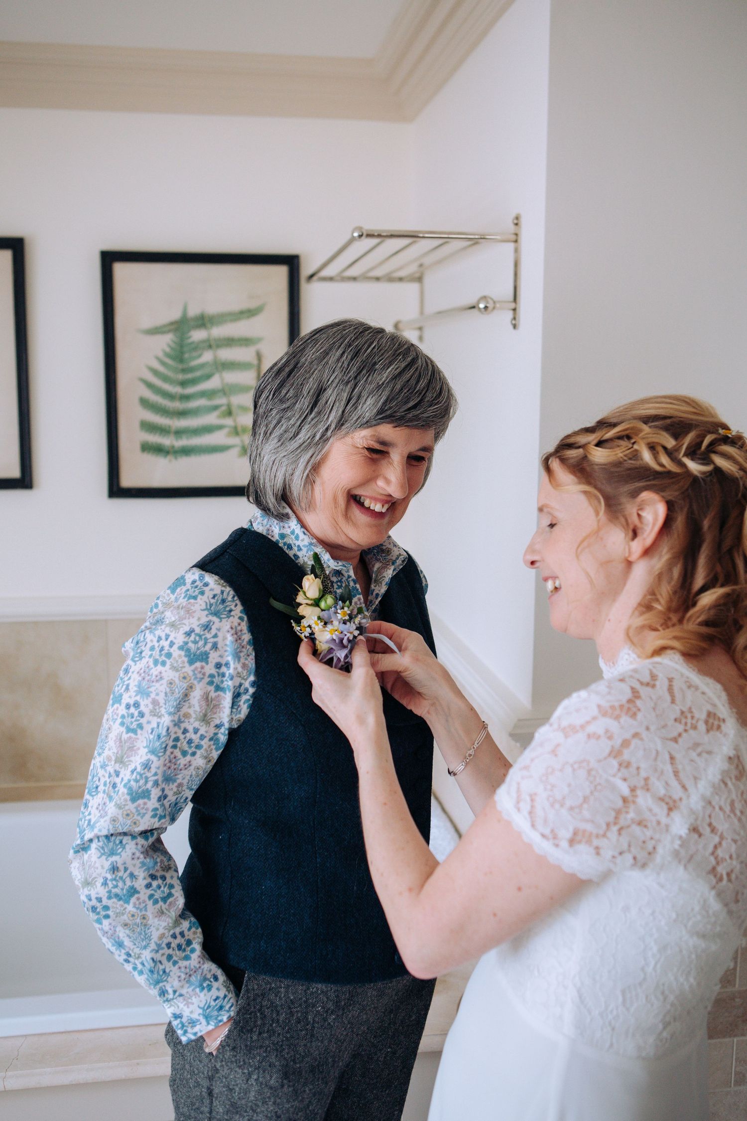 Four sequential photos show an emotional moment between two people sharing joyful laughter and embraces in a light-filled room.