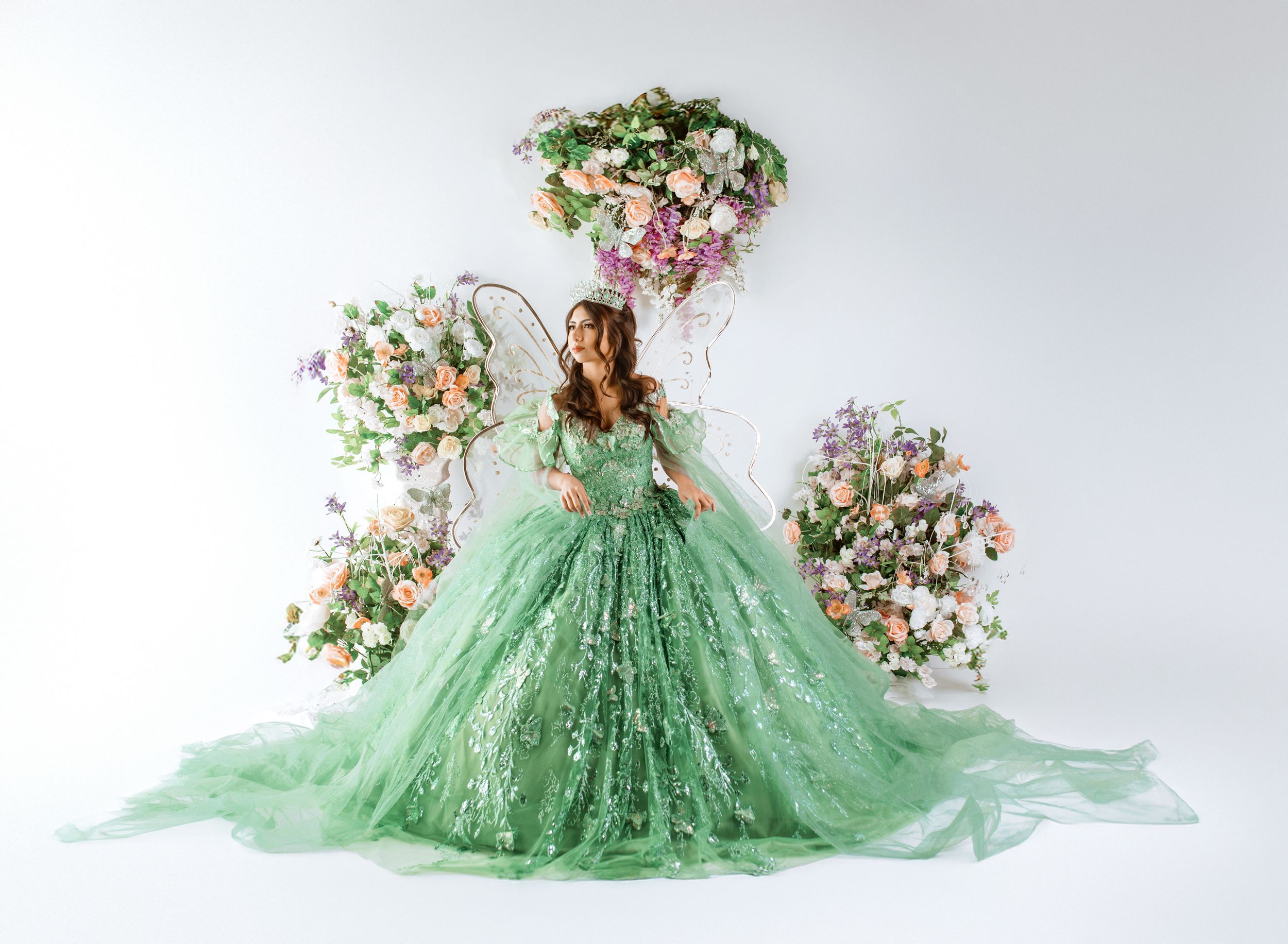 A stunning mint green tulle ball gown with floral embellishments photographed in multiple angles on a white backdrop.