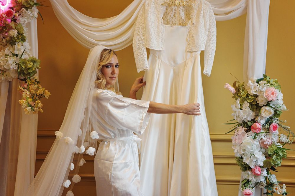 bride putting on wedding dress during Houston wedding preparations