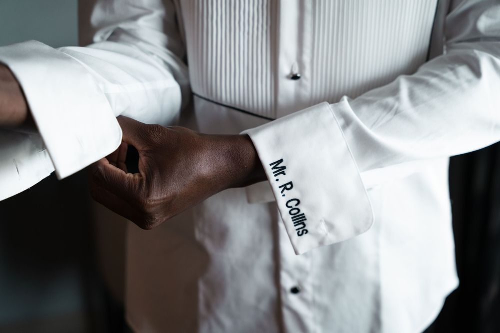 Close-up view of white chef coats and uniforms in professional kitchen setting.