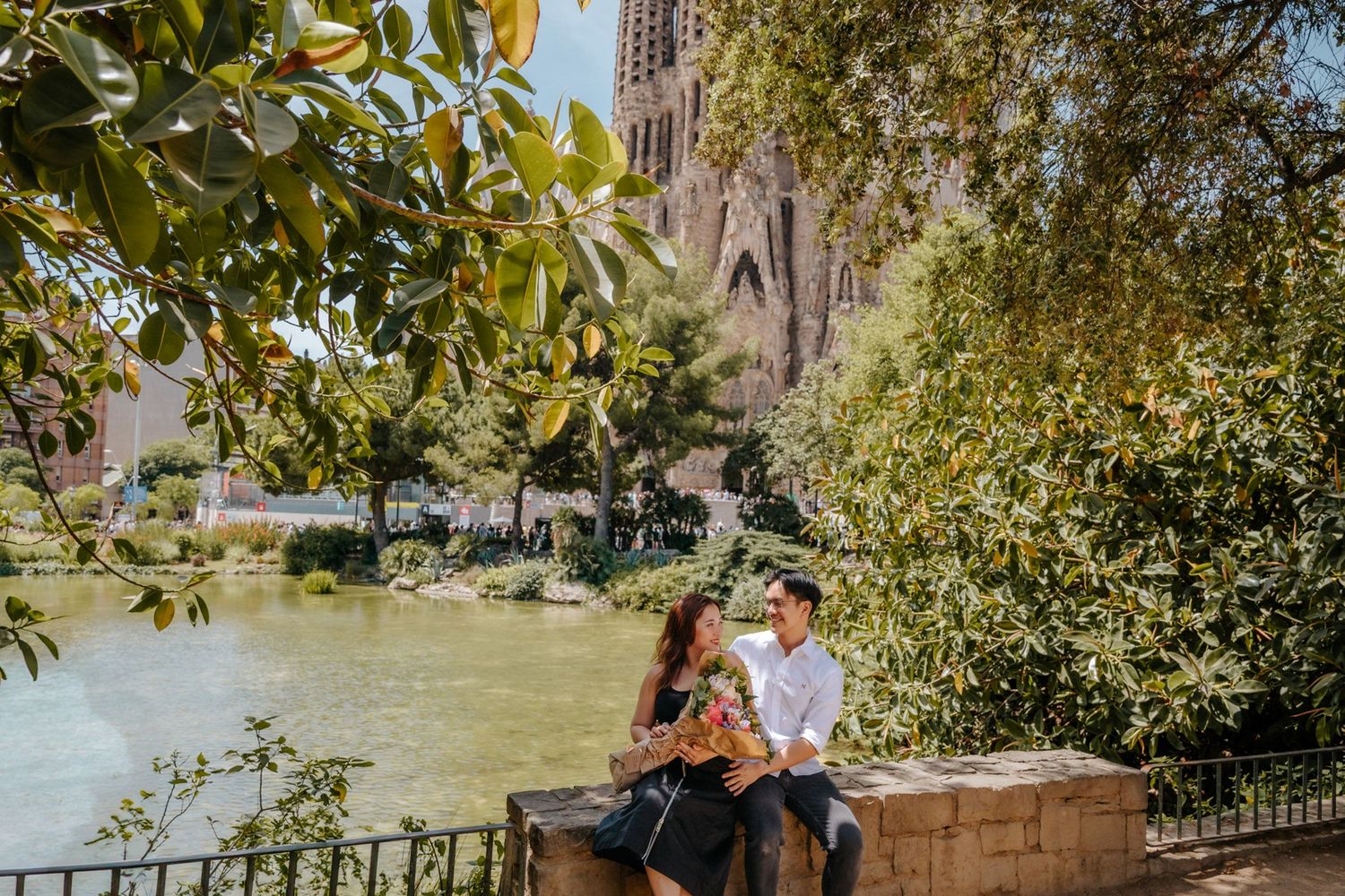 Couple hugging after surprise proposal in Barcelona near Sagrada Familia