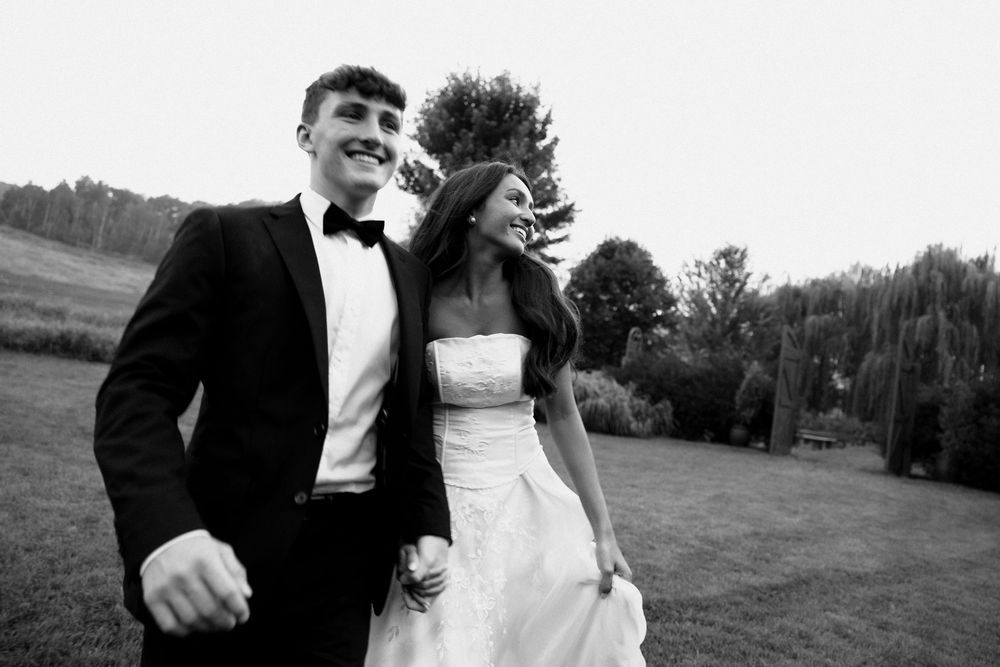 Black and white wedding photo collage showing candid moments of a couple dancing and embracing outdoors.