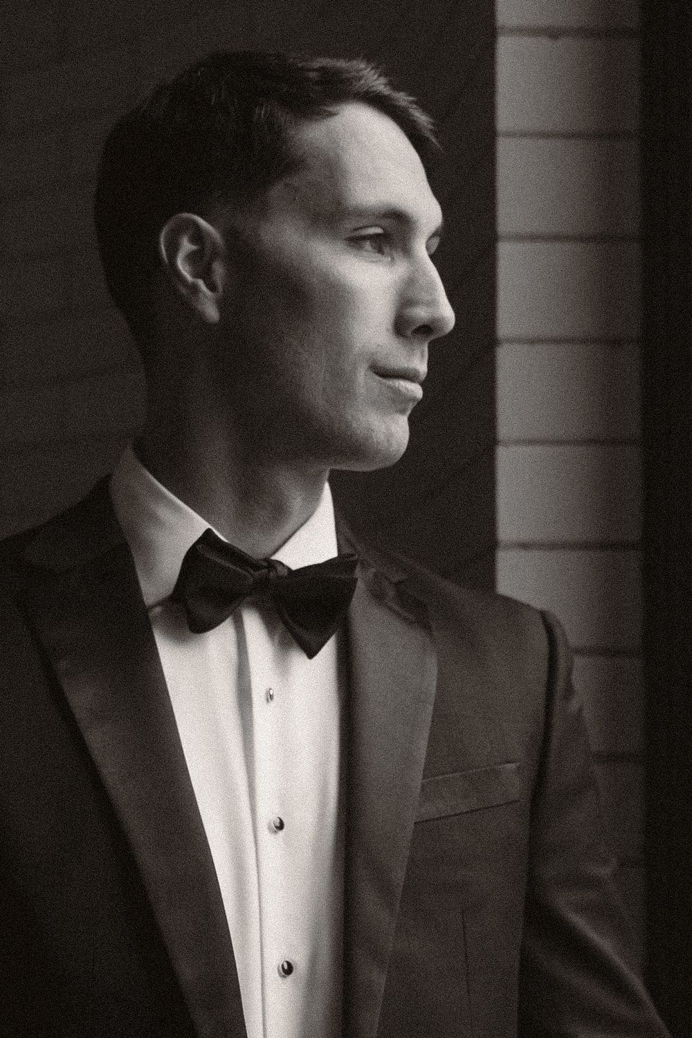 Black and white portrait series showing different angles of a person in formal attire with a bow tie.