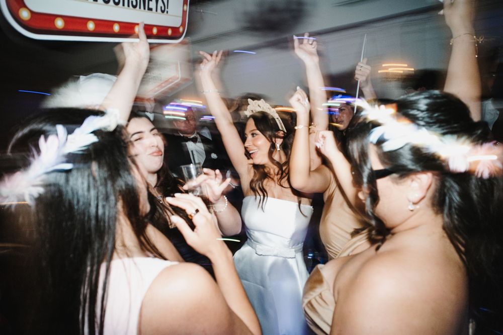 A group of people dancing and having fun at a crowded nightclub with blurred motion effects.
