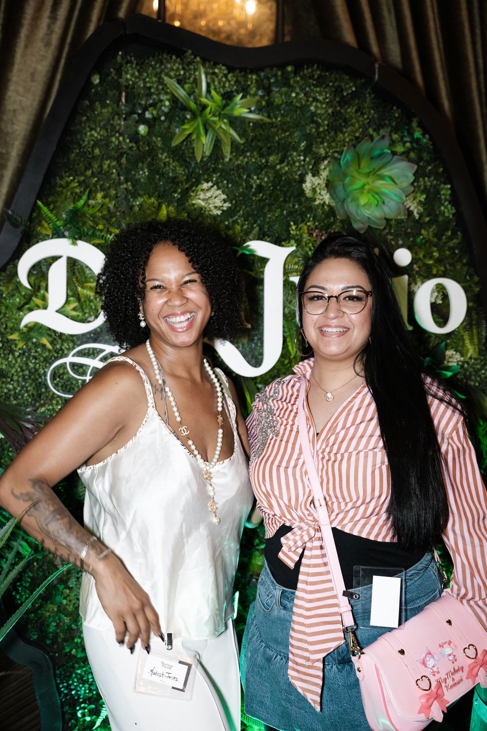 Two friends pose together outdoors wearing red and white striped tops and smiling for a series of casual photos.