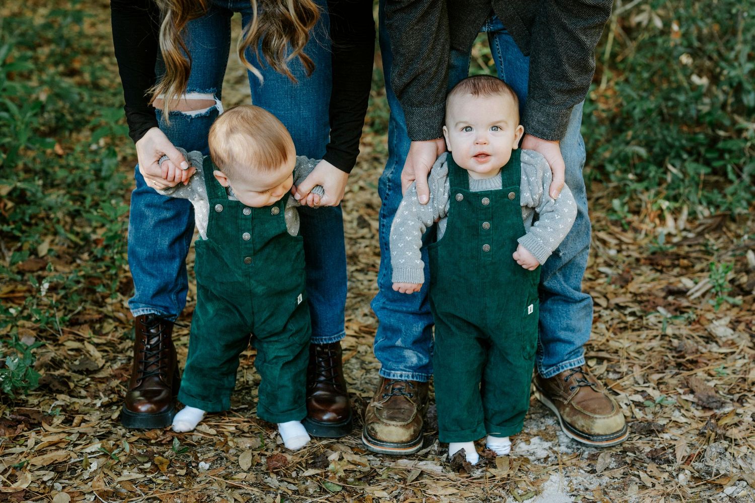 A series of photos showing feet and legs of family members wearing jeans and overalls standing together outdoors.