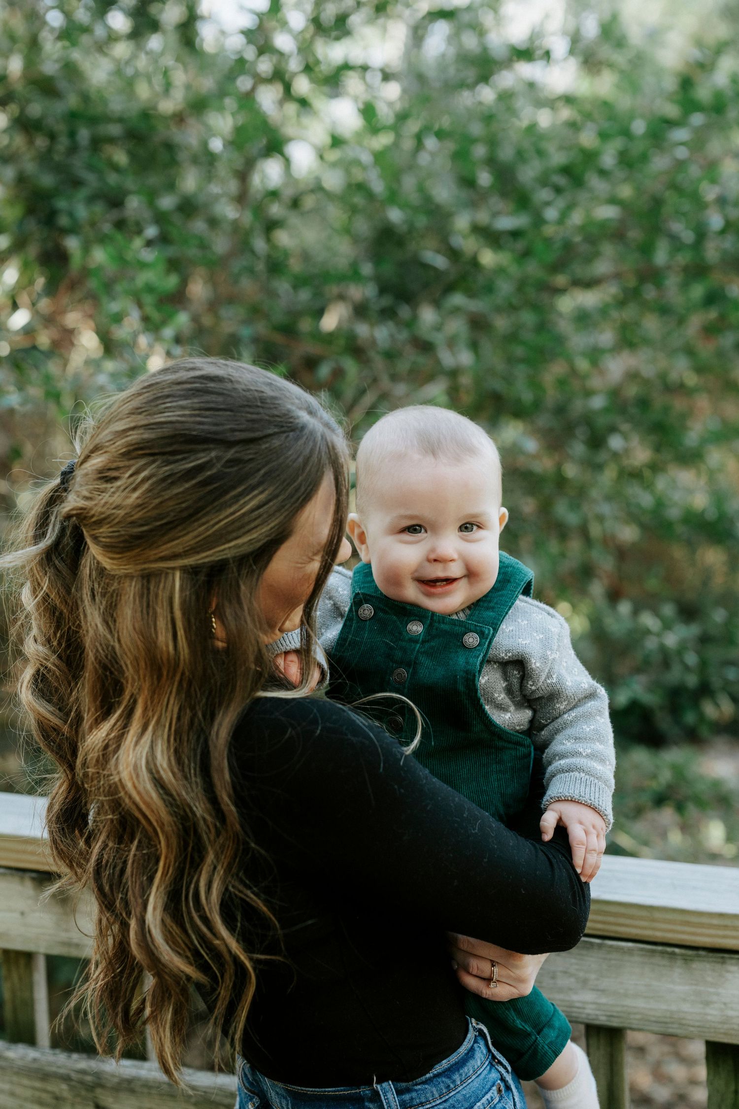 Candid outdoor family moments showing playful interaction on sunny day.