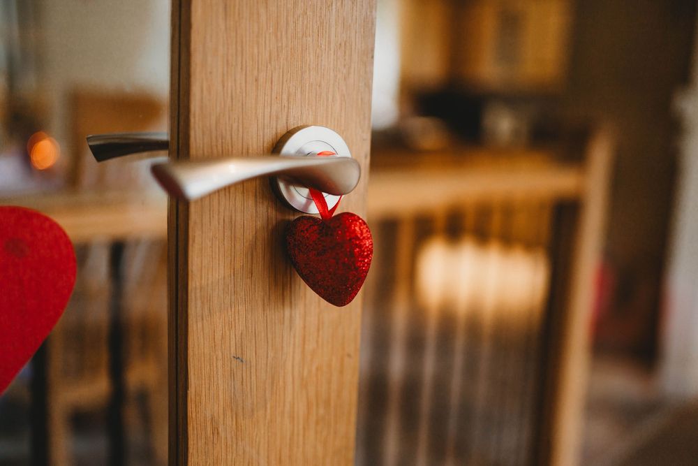 Wooden wall decor with red heart accents creates a warm and romantic atmosphere in a rustic interior setting.