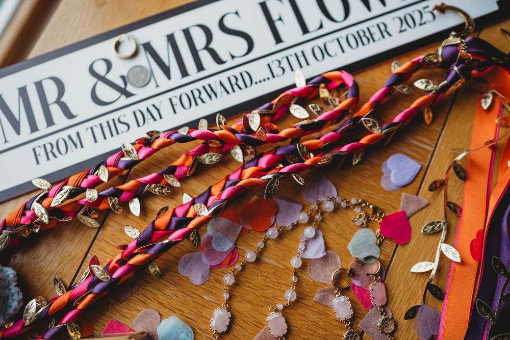 Wooden table decorated with 'Mr & Mrs' text and scattered red and pink heart confetti for a wedding celebration.