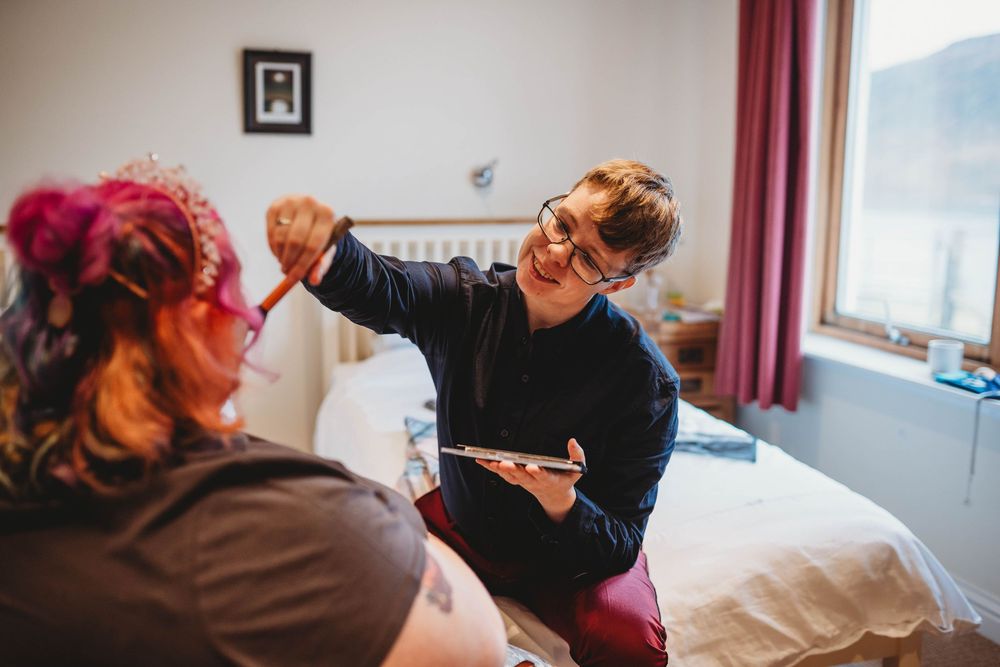 A healthcare worker in protective mask and gloves performs a medical examination on an elderly patient in a clinical setting.