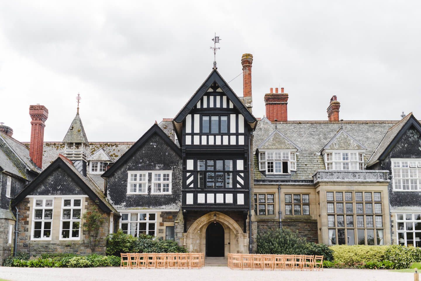 Row of traditional Tudor and Victorian style buildings with distinctive architectural details.