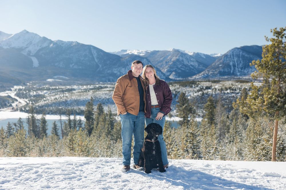 People enjoying a winter day with scenic mountain views and snow-covered landscapes in the background.