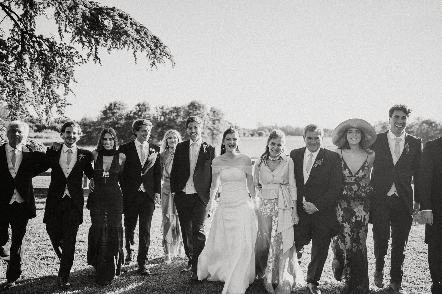 A vintage panoramic black and white photograph shows a large group of people lined up outdoors for a formal gathering.