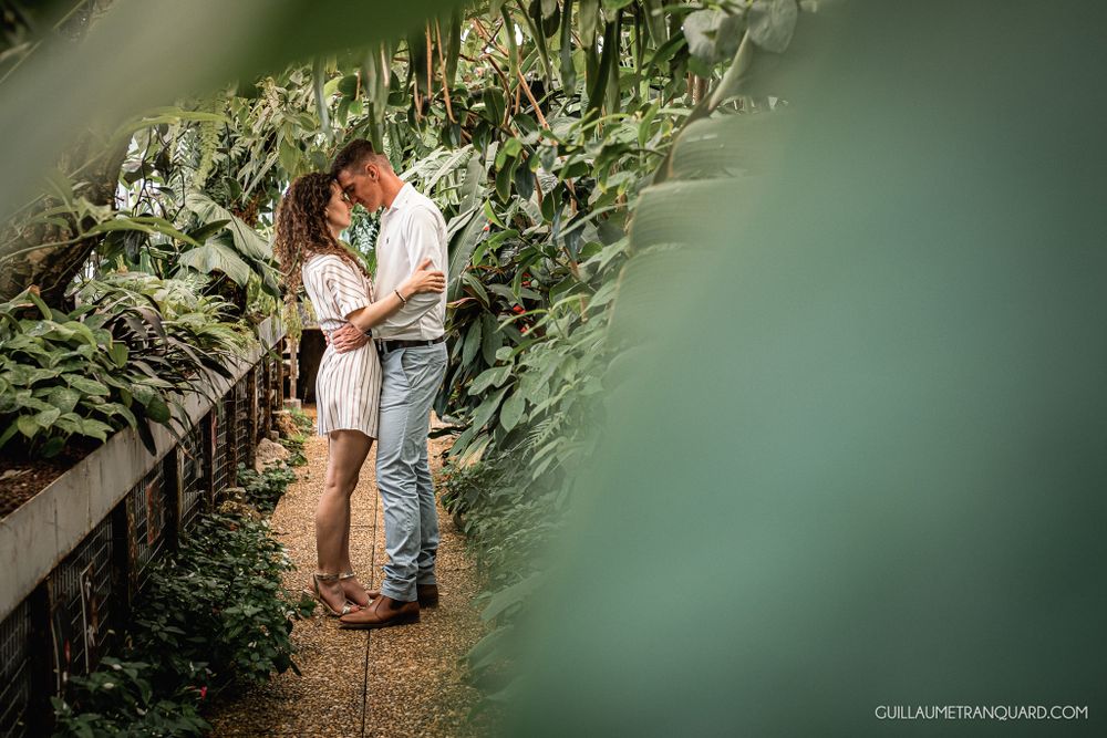 Greenhouse engagement session with soft teal tones and natural lighting.