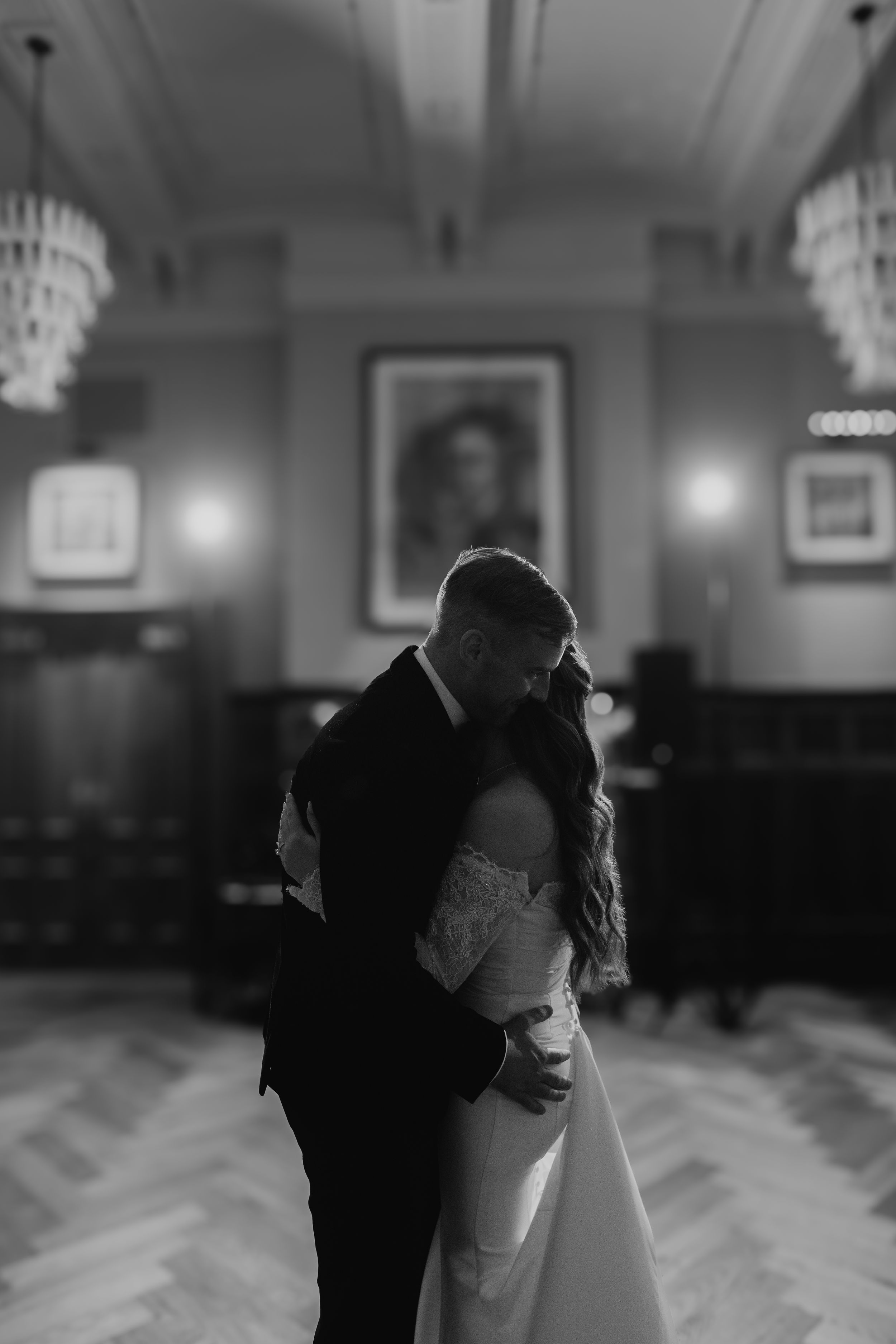 A black and white photo sequence shows a couple dancing together in an elegant ballroom setting.