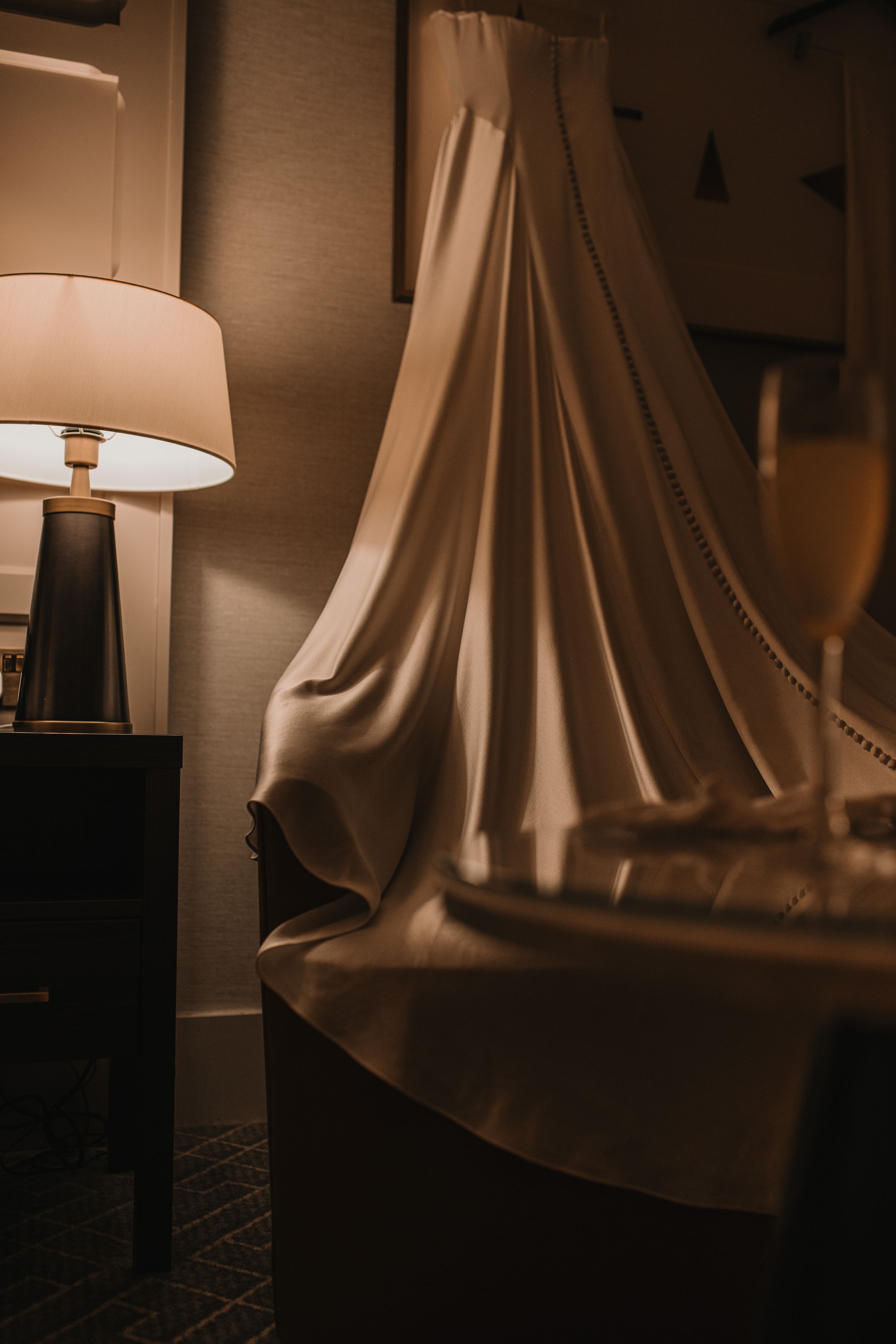 Close-up series of a modern white lampshade creating dramatic shadows and curves in warm lighting.