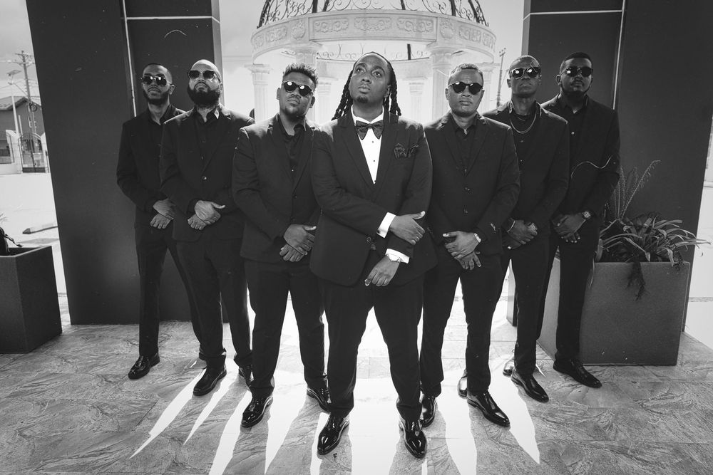 A black and white collage of wedding party members walking and posing together in formal attire.